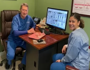 Dr. Mike Shulman and dental assistant reviewing digital X-rays on a computer monitor at R&S Dental Associates in Clifton, NJ.