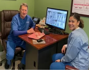 Dr. Mike Shulman and a dental assistant shown on a computer monitor at R&S Dental Associates in Clifton, NJ.