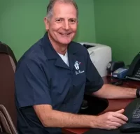 Dr. Roberto Russo, co-founder and dentist at R&S Dental Associates in Clifton, NJ, sitting at his desk.